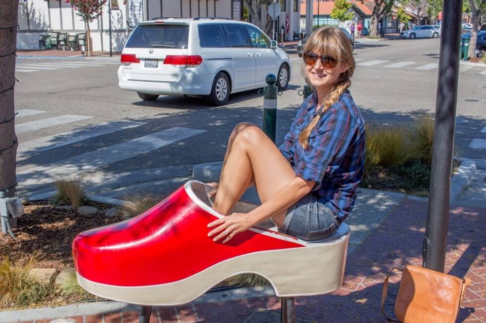 Sitting in the big red shoe Solvang CA