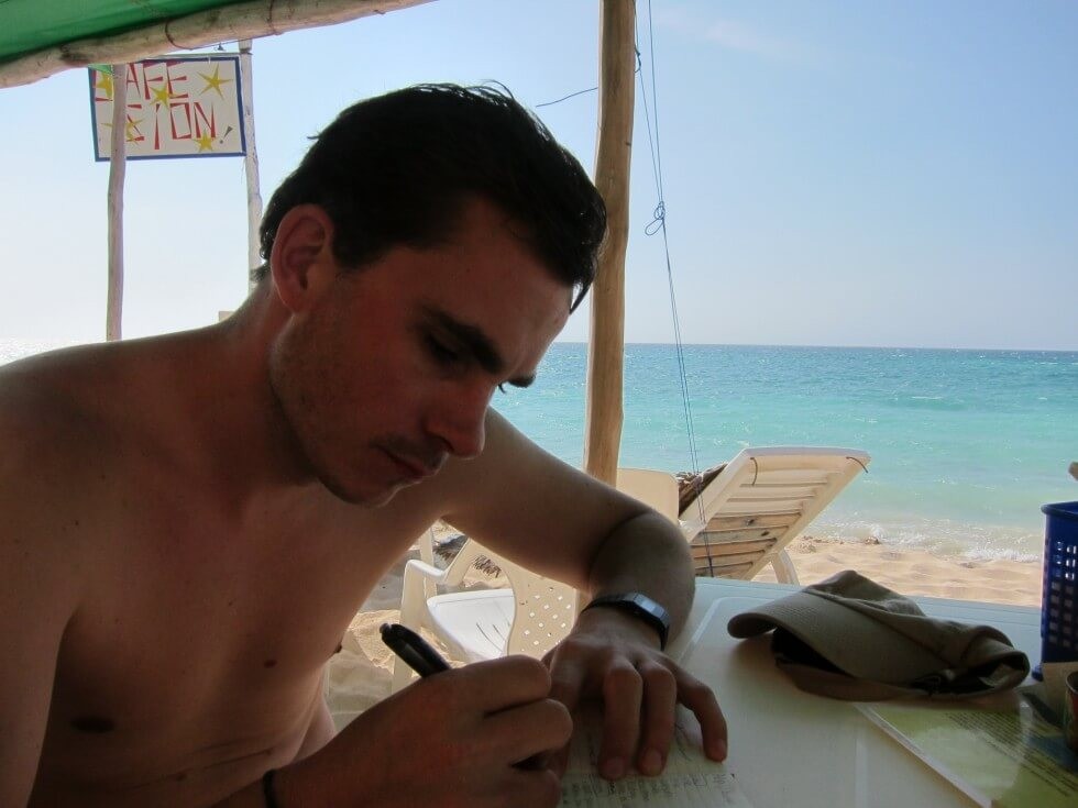 79 - Tom writing in Playa Blanca, Colombia